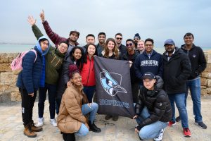 MSEM students holding a Johns Hopkins flag during the Immersion program in Israel.