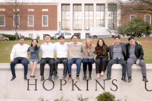 MSEM students posing on Hopkins sign during master's convocation.