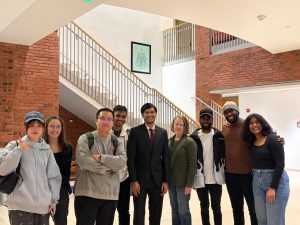 Devothama, Julie Reiser, and MSEM students in the hallway outside of the "Carousel of Ideas" TEDxJHU event.