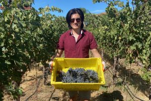 Tyler with a basket of grapes at a winery in Davis, CA.